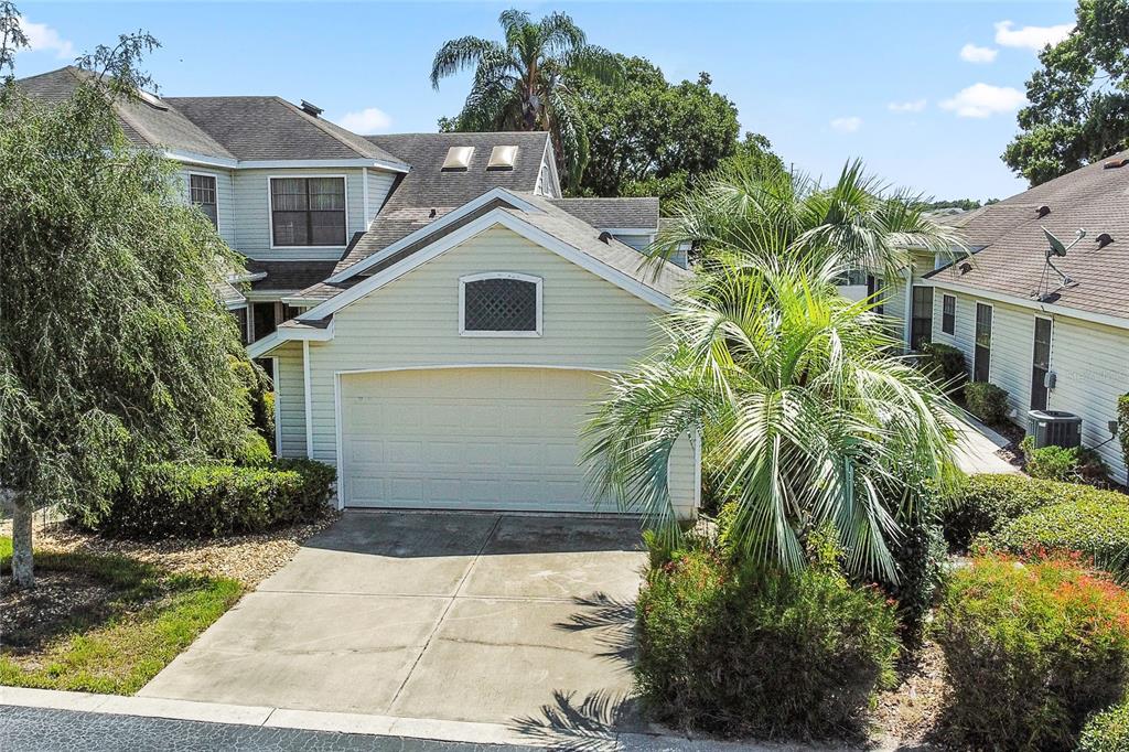 a front view of a house with a yard and trees