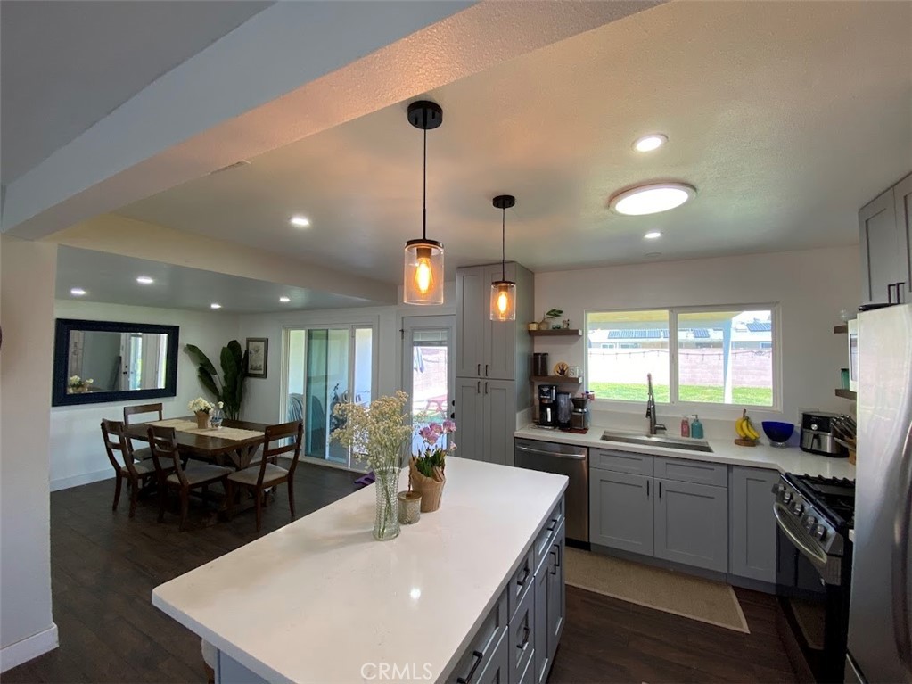 a kitchen with counter space appliances and a dining table