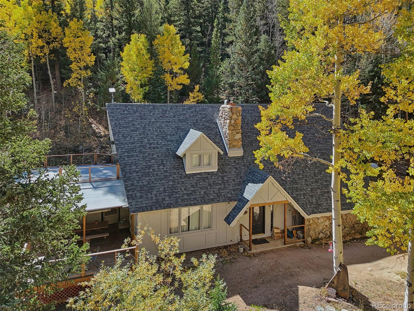 an aerial view of a house with a yard and garden