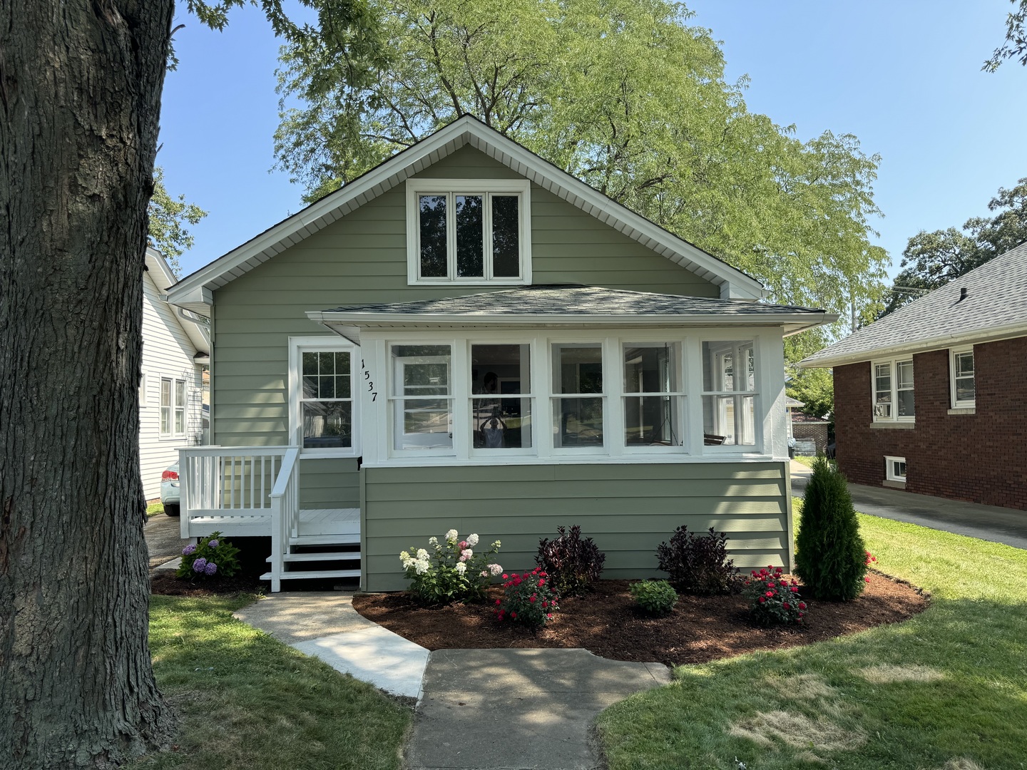 a front view of a house with garden