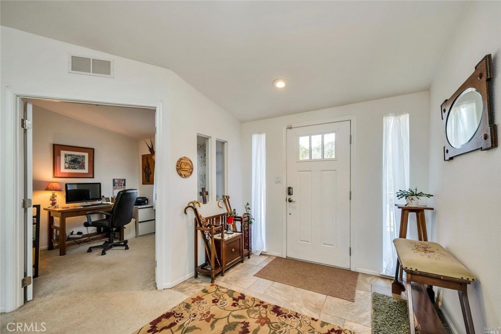 a view of living room filled with furniture and wooden floor