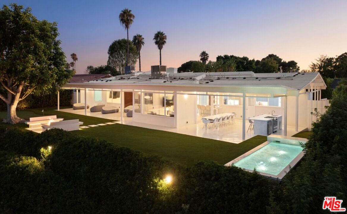 a view of swimming pool with outdoor seating and a buildings in the background