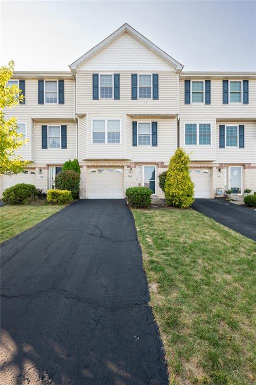 a front view of a residential apartment building with a yard