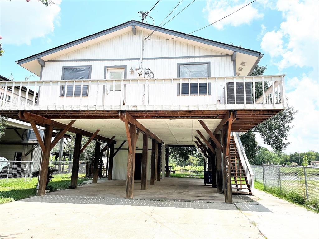 a view of a house with a porch and furniture