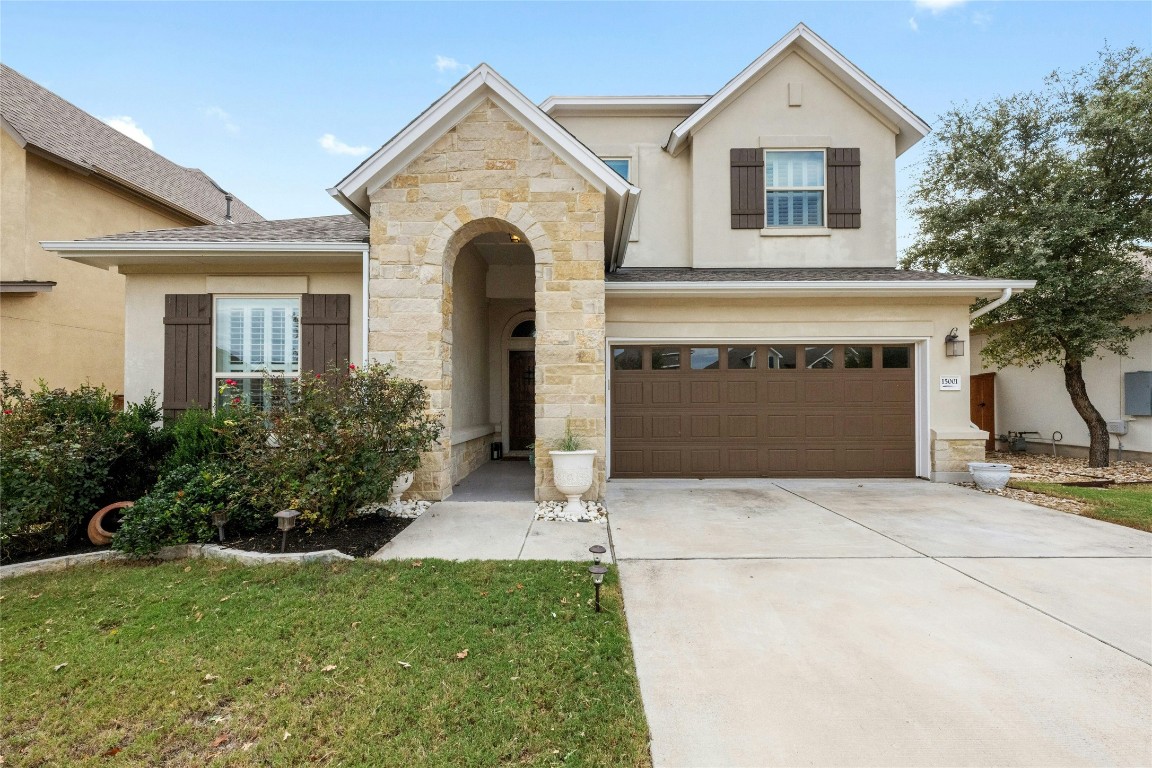 a front view of a house with a yard and garage