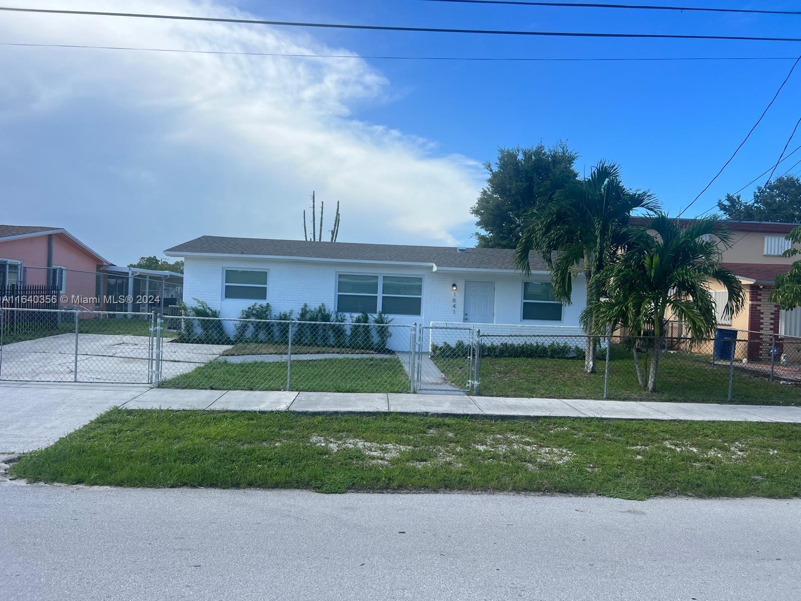 a view of a house next to a yard