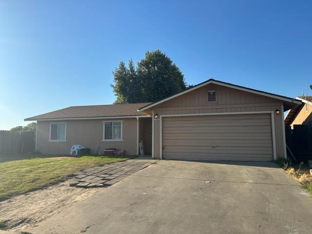 a view of house with a yard and garage