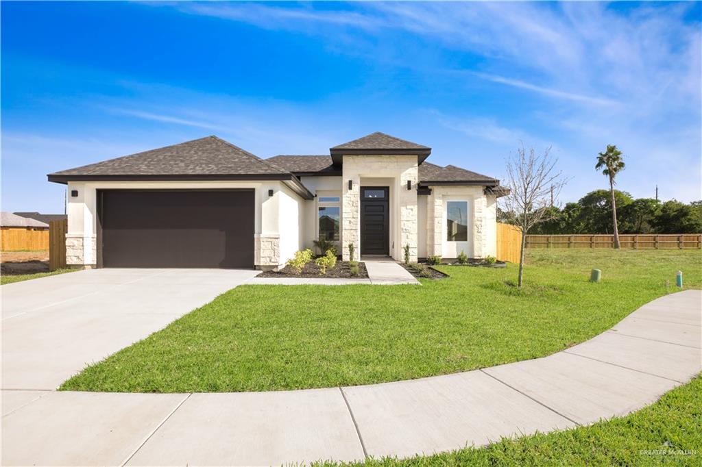 Prairie-style house with a garage and a front lawn