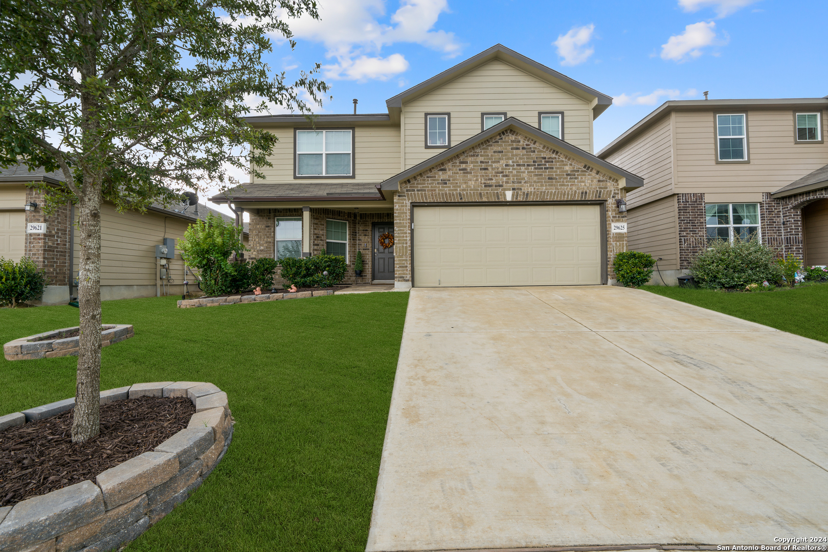 a front view of a house with a yard and garage