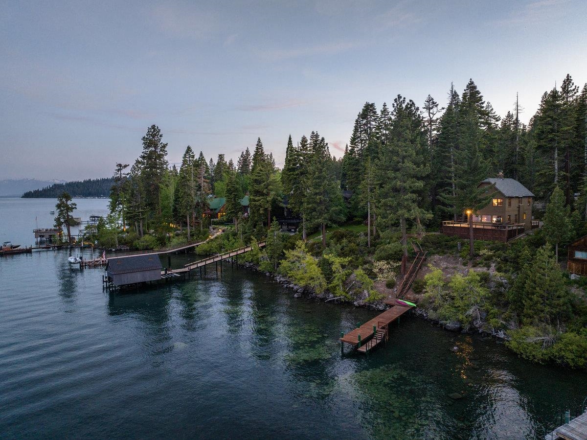 an aerial view of a house with swimming pool outdoor seating and yard