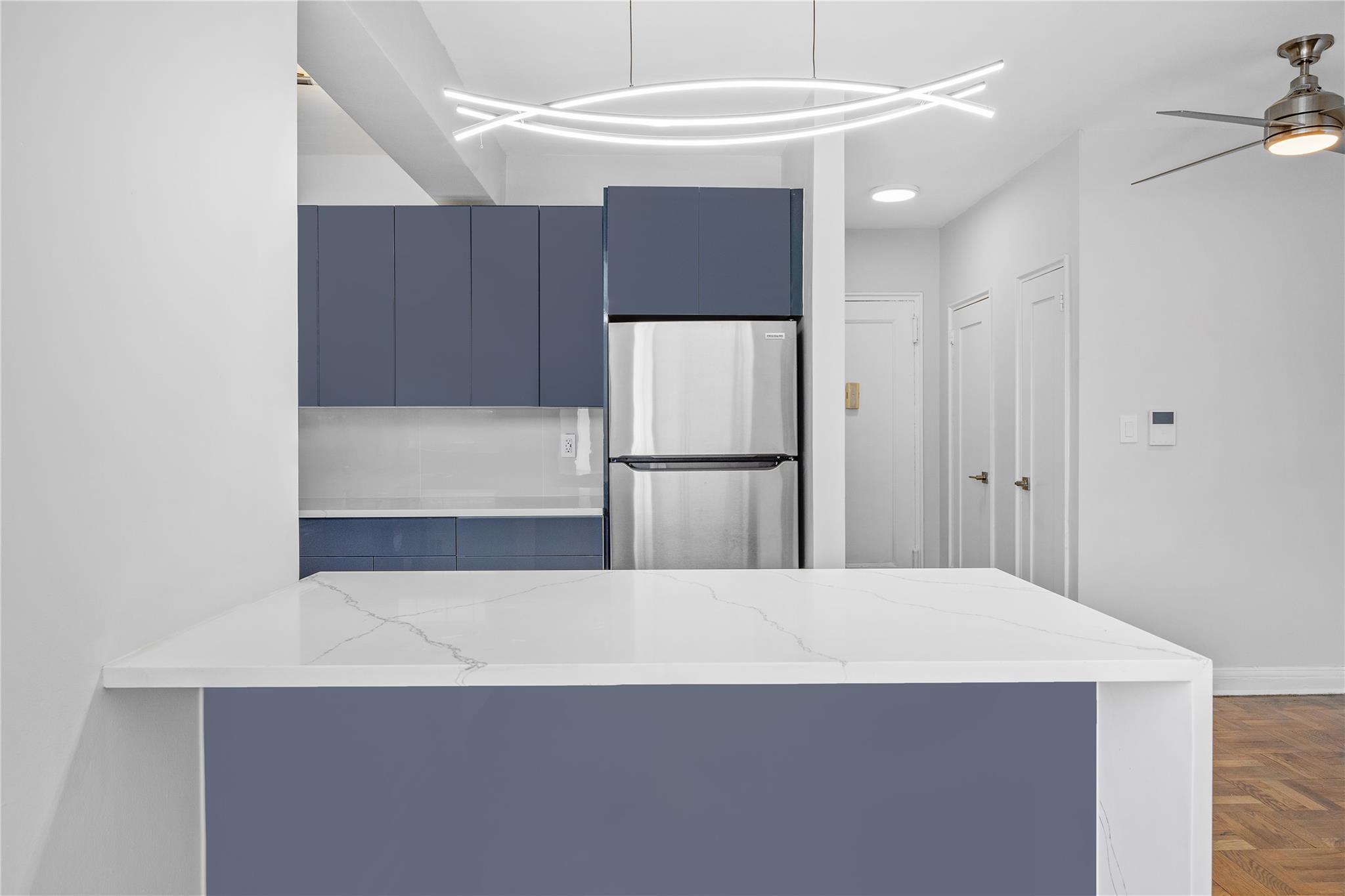 a large white kitchen with cabinets