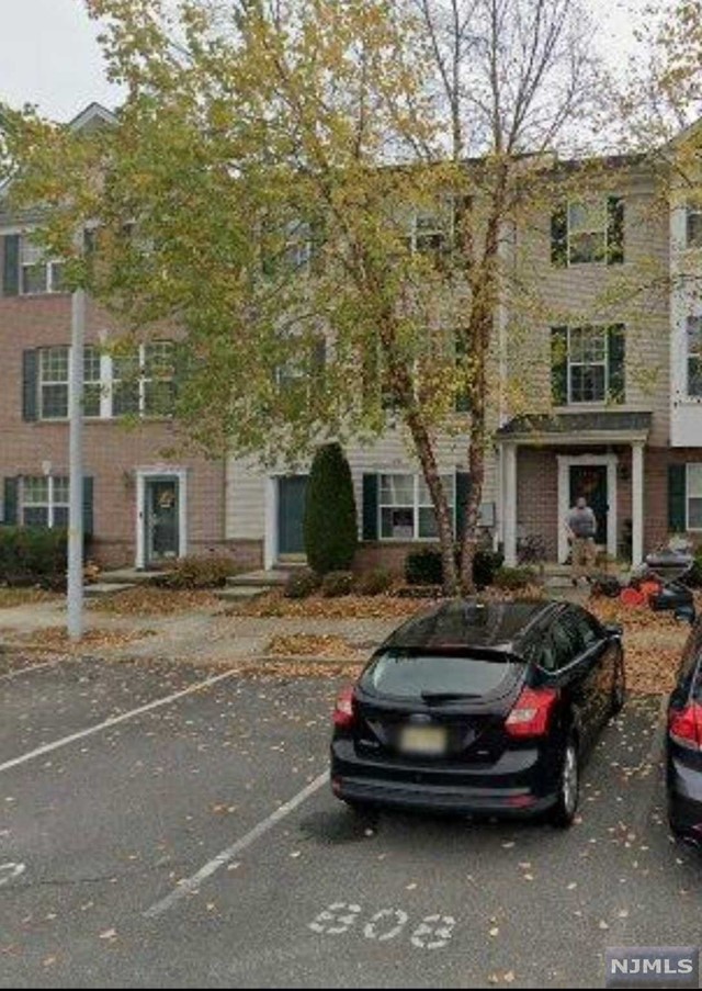 a car parked in front of a brick house