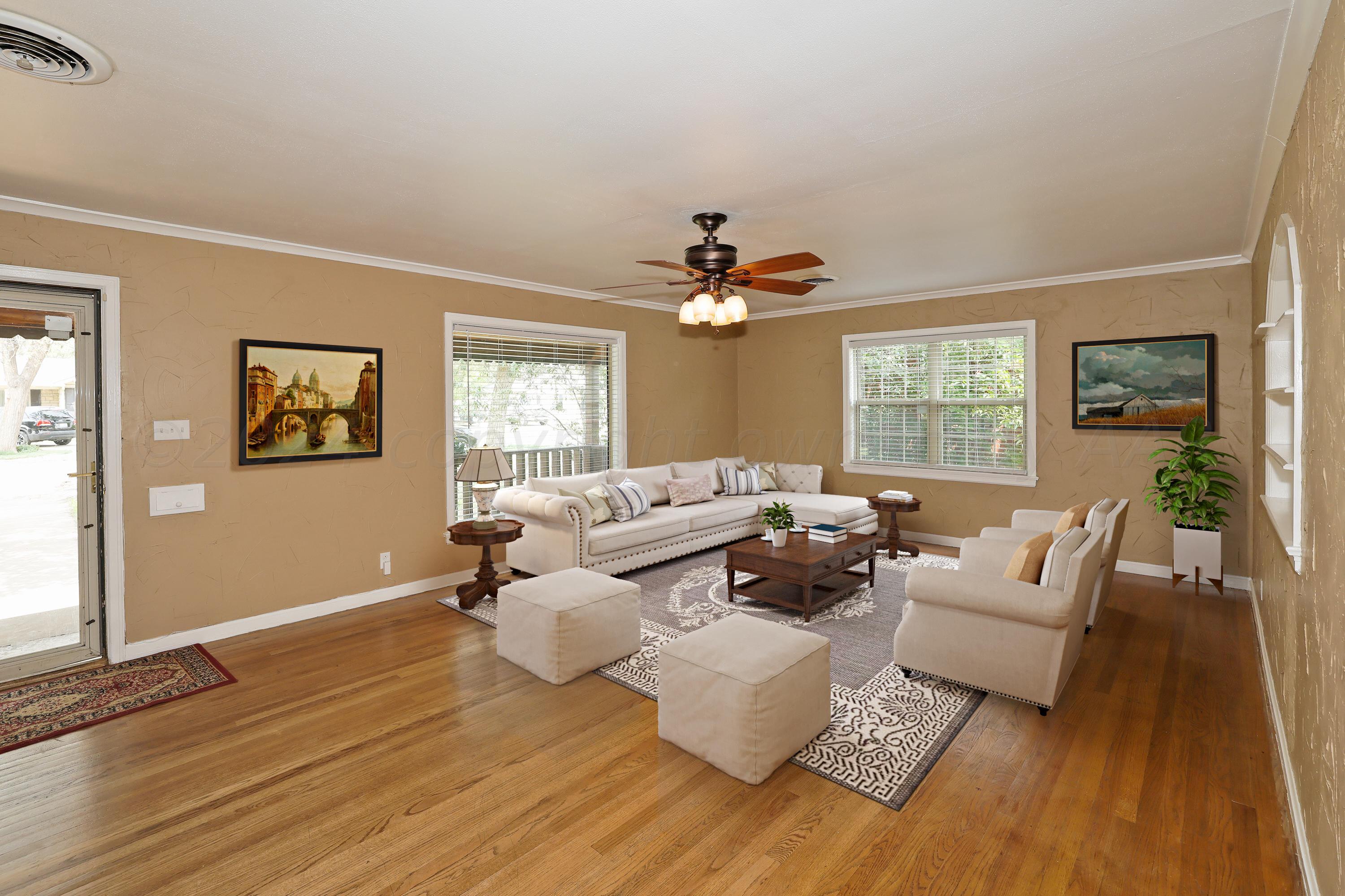 a living room with furniture and a large window