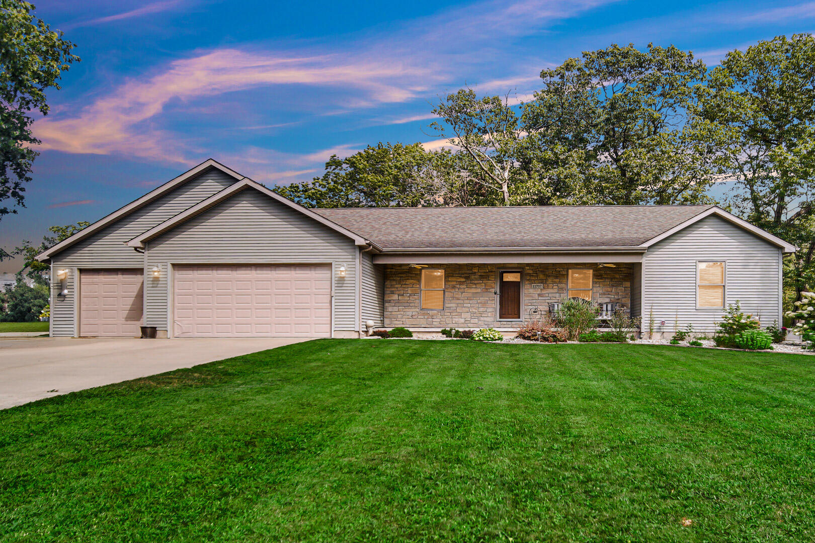 a front view of a house with a yard and garage