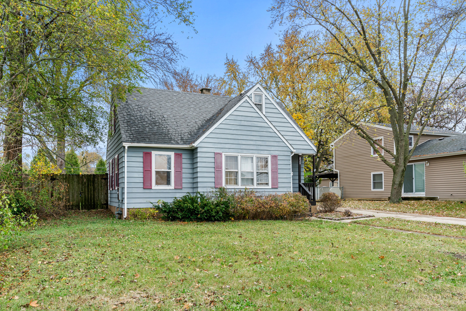 a view of a house with a yard and potted plants