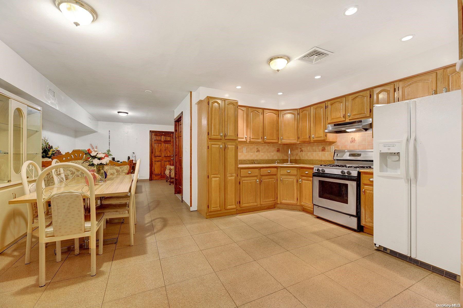 a kitchen with cabinets and stainless steel appliances