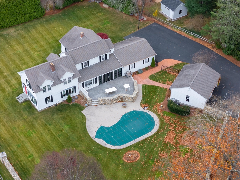 an aerial view of a house with a swimming pool and outdoor space