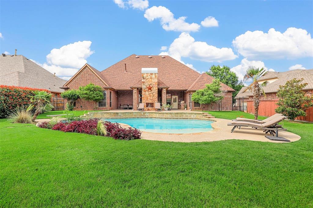 a view of a house with swimming pool and yard