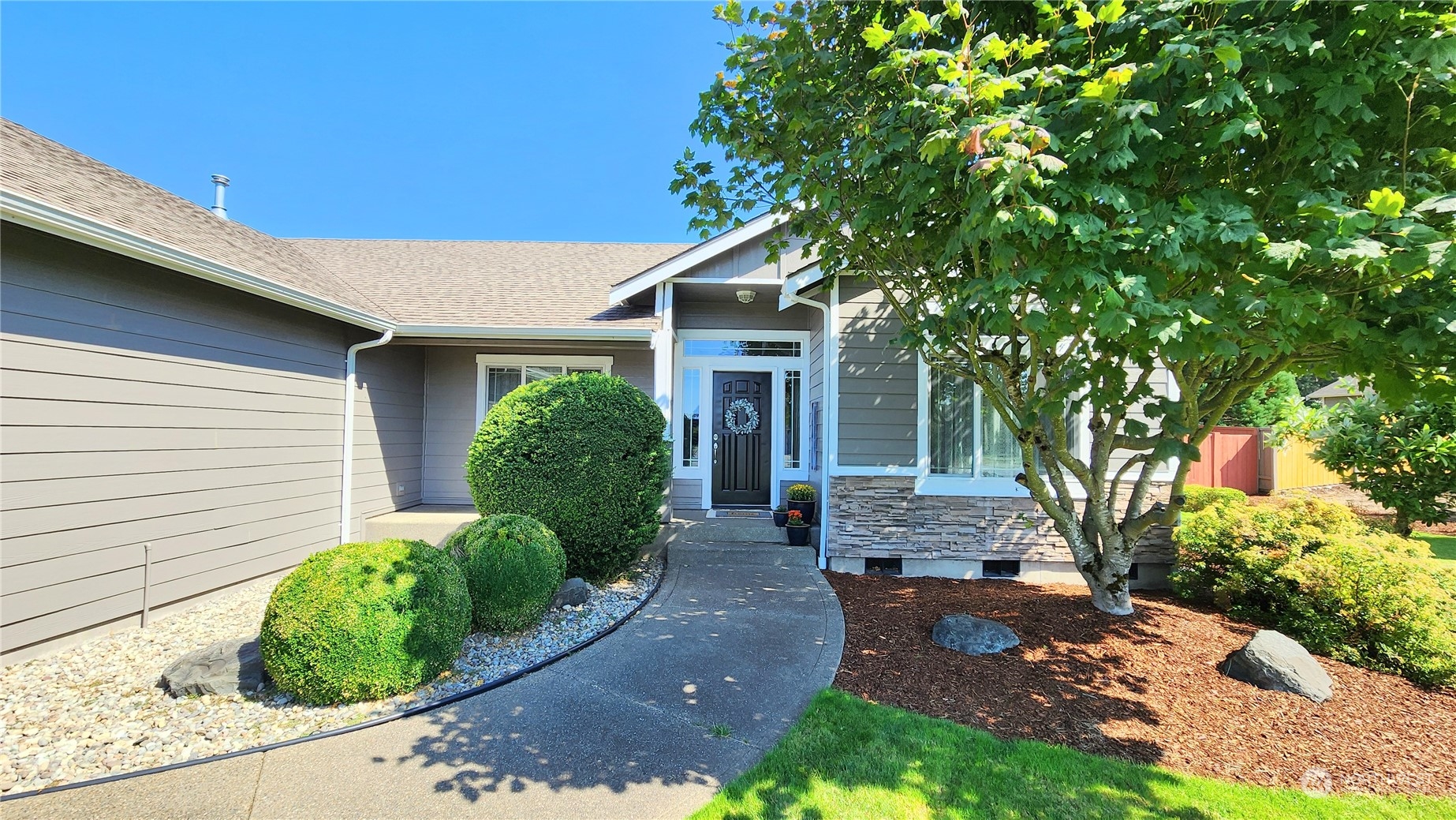 a front view of a house with garden