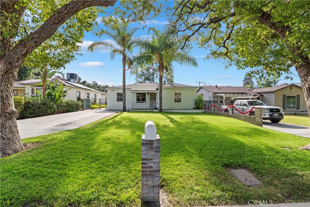 a front view of house with yard and green space