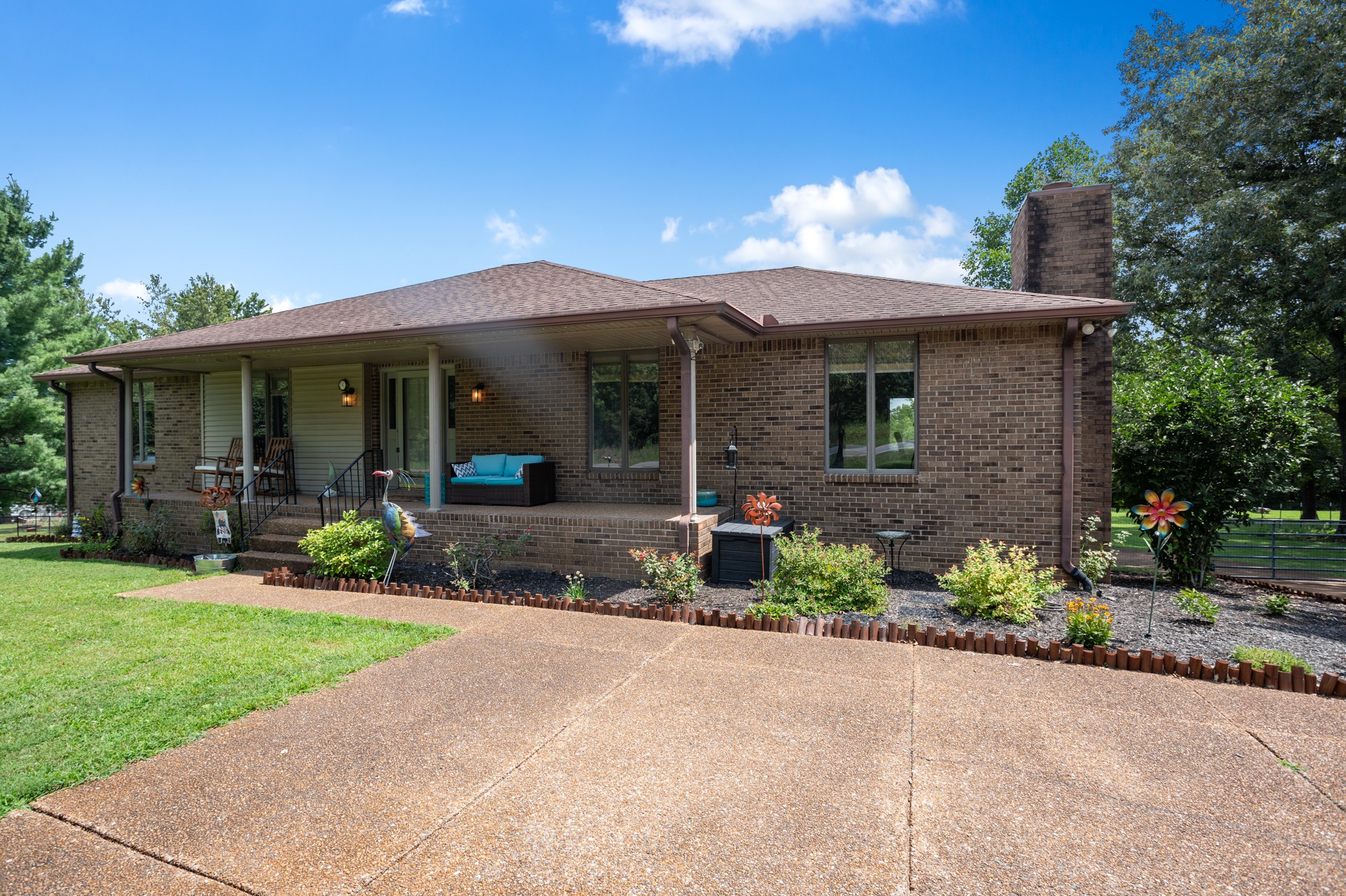 a view of a house with a yard and garden