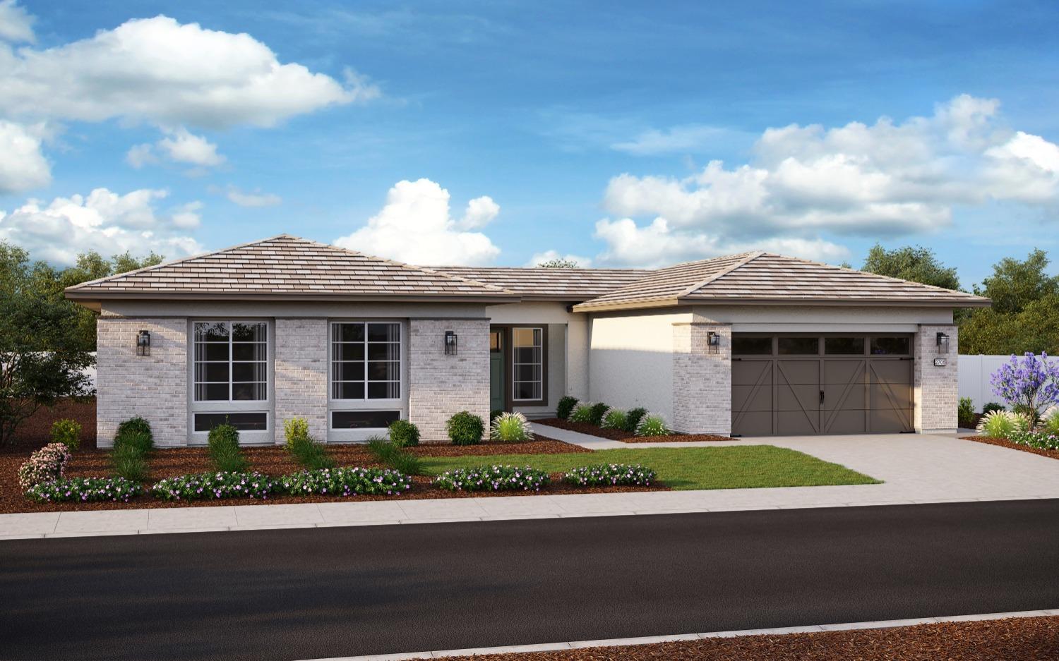 a front view of a house with a garden and garage