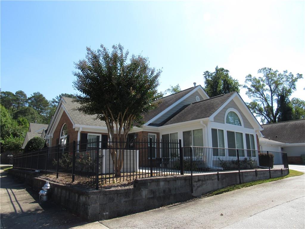 a front view of a house with garage and garden