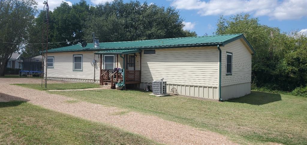 a view of a house with a yard and garage