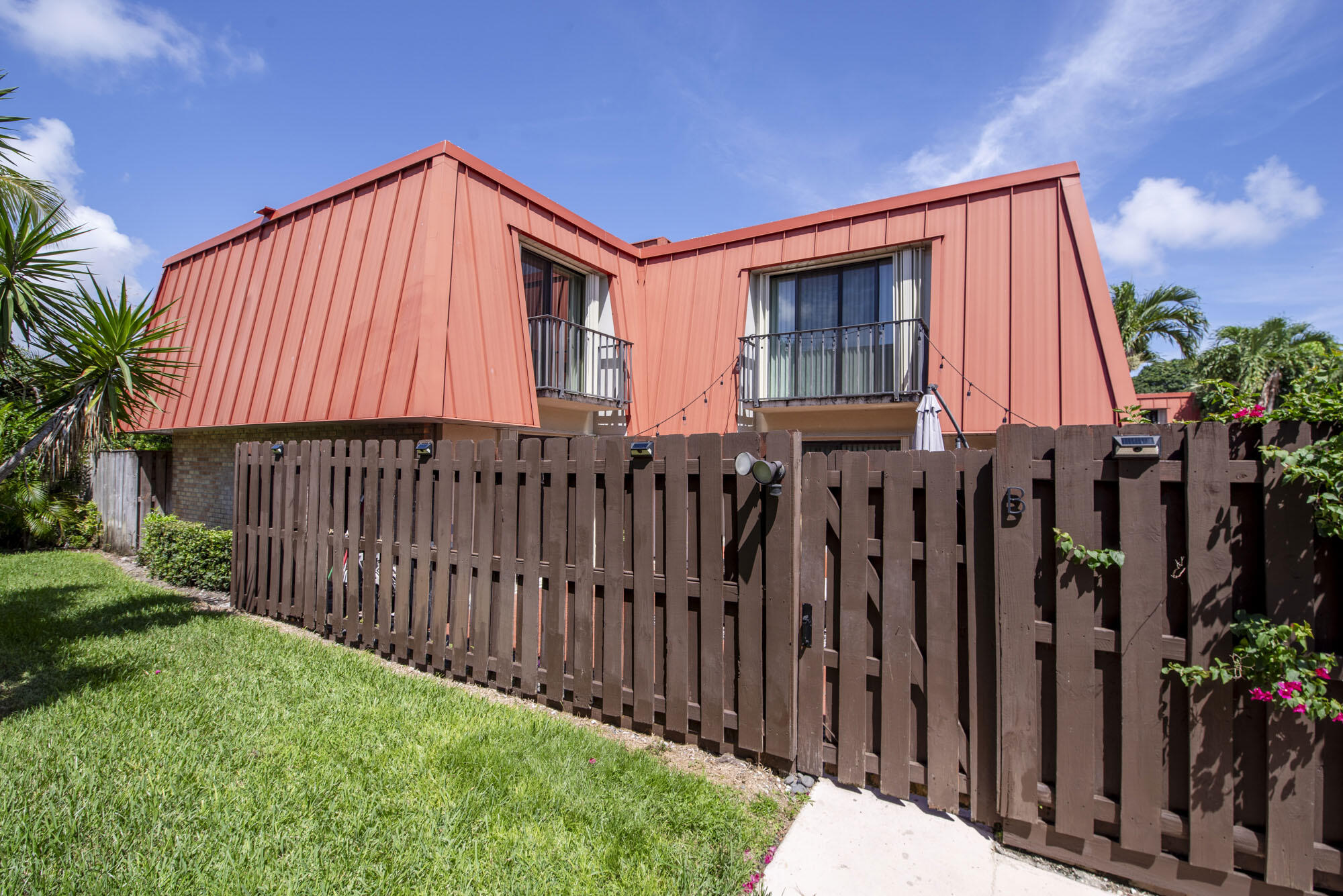 a view of a house with wooden fence