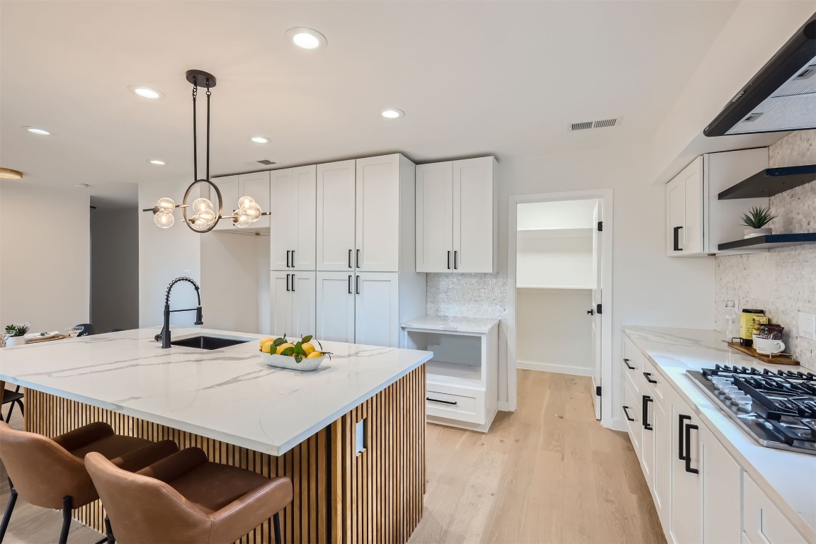 a kitchen with a table chairs stove and cabinets