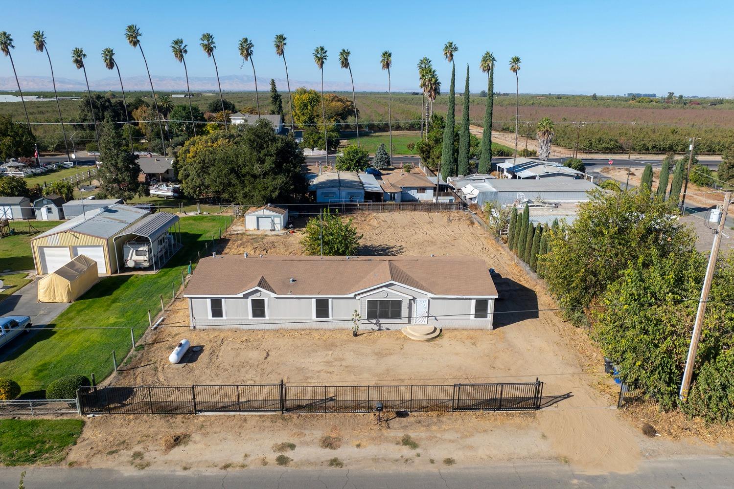 a aerial view of a house with a yard and lake view