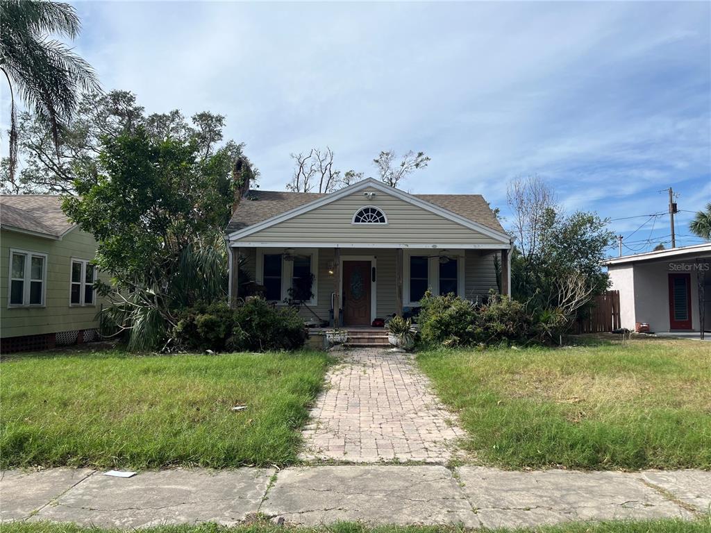 a front view of house with yard and green space