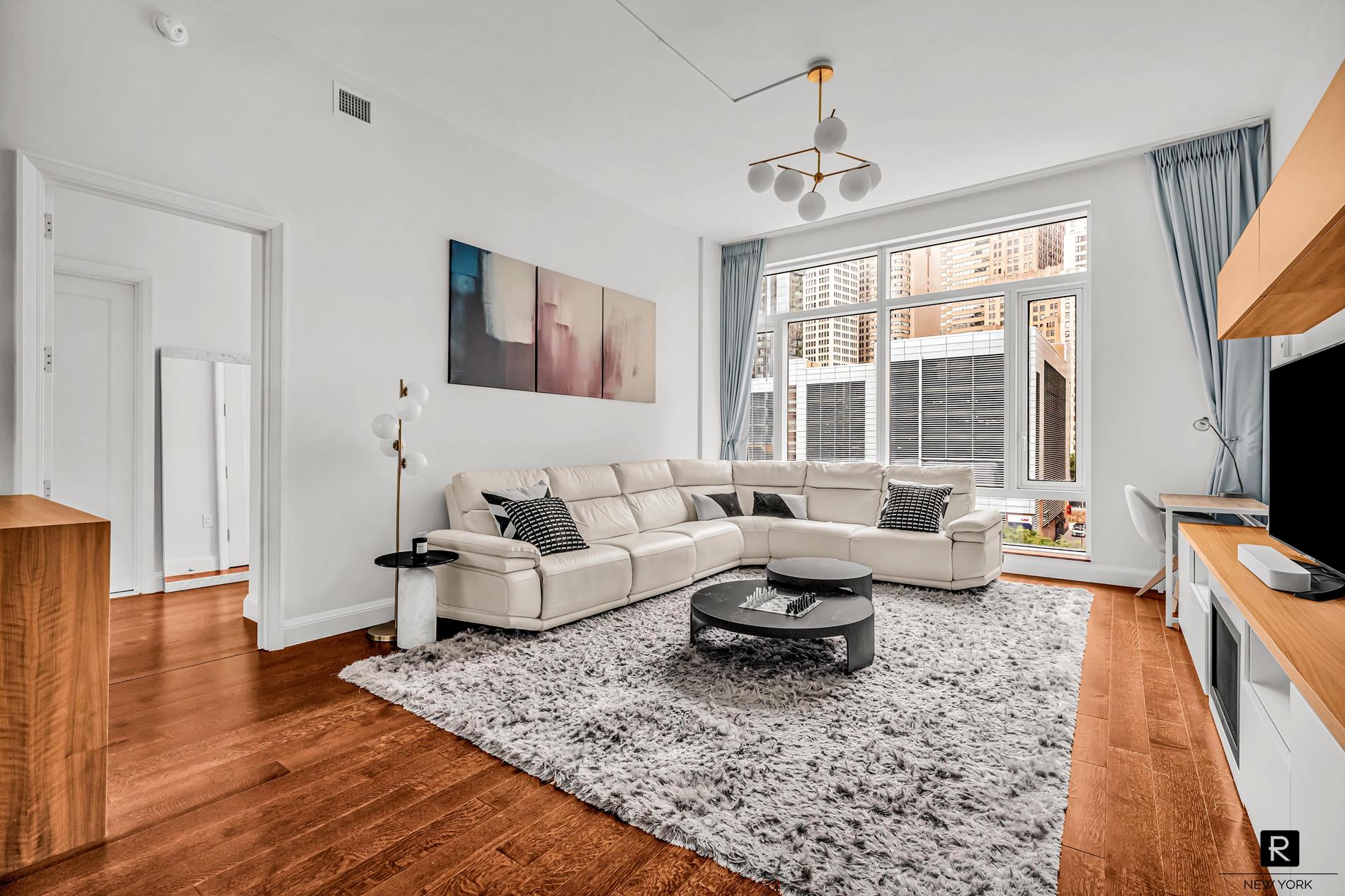 a living room with fireplace furniture and a flat screen tv