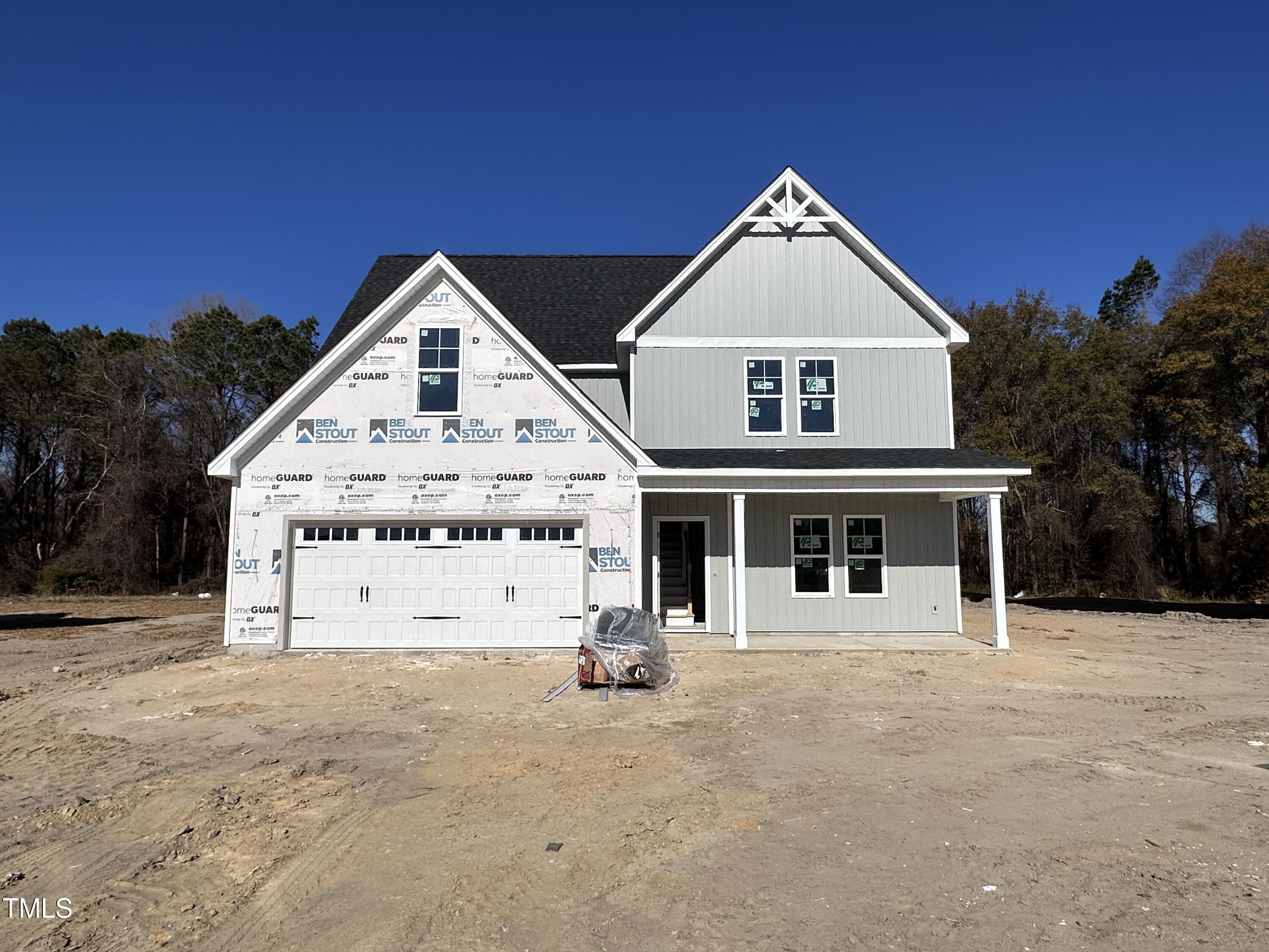 a view of house with yard and garage