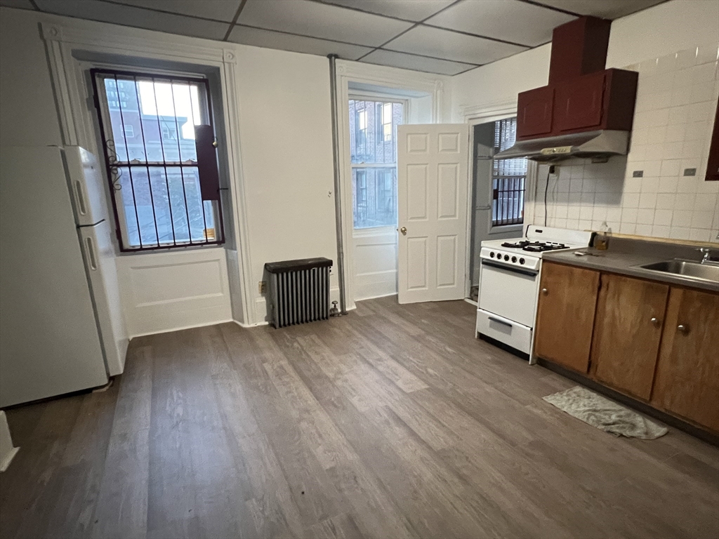 a kitchen with stainless steel appliances granite countertop a stove and a refrigerator