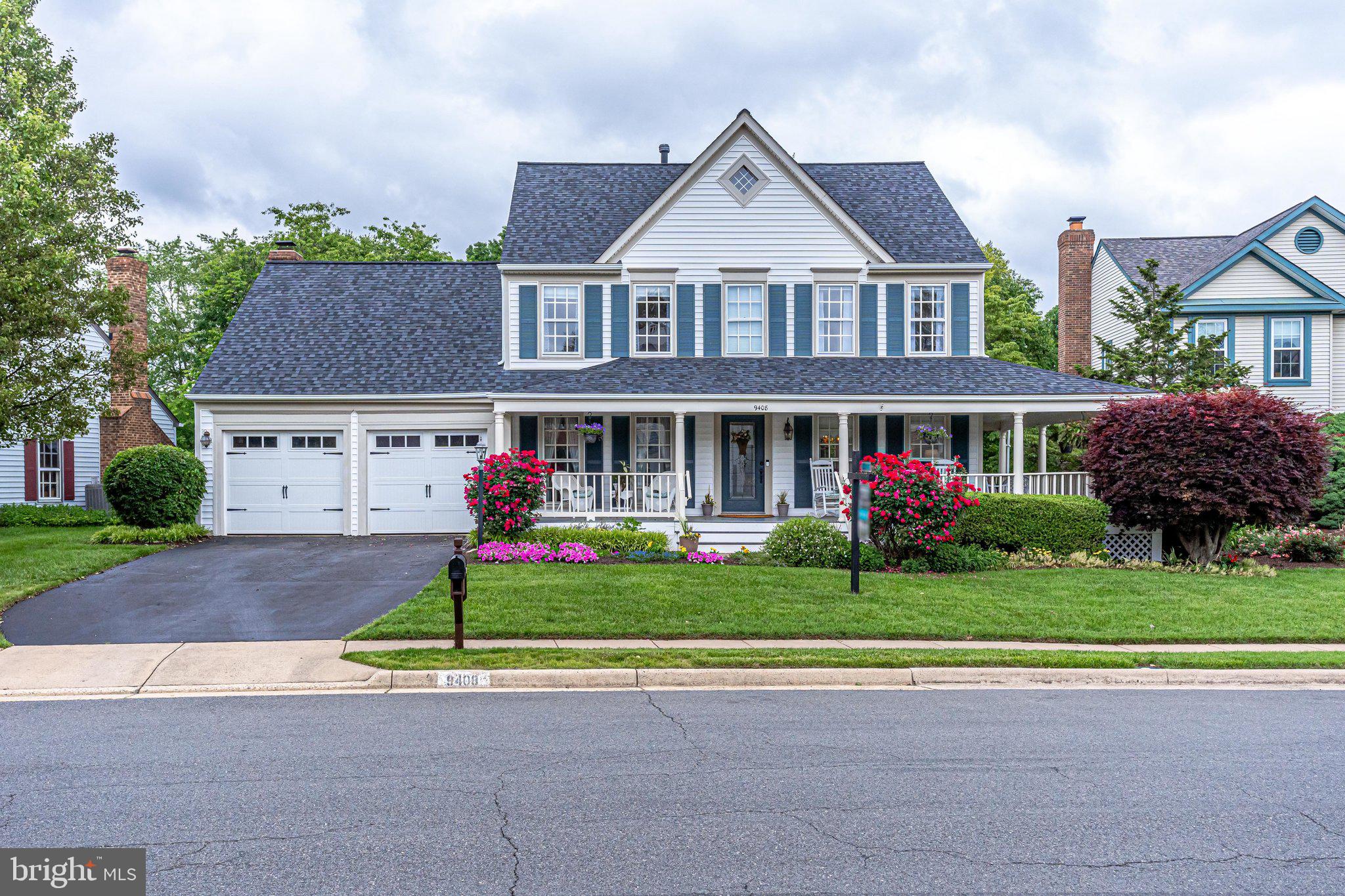 a front view of houses with yard and green space