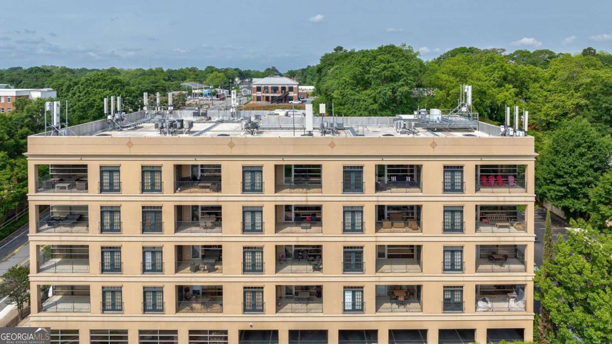 a view of building with a lot of windows and trees