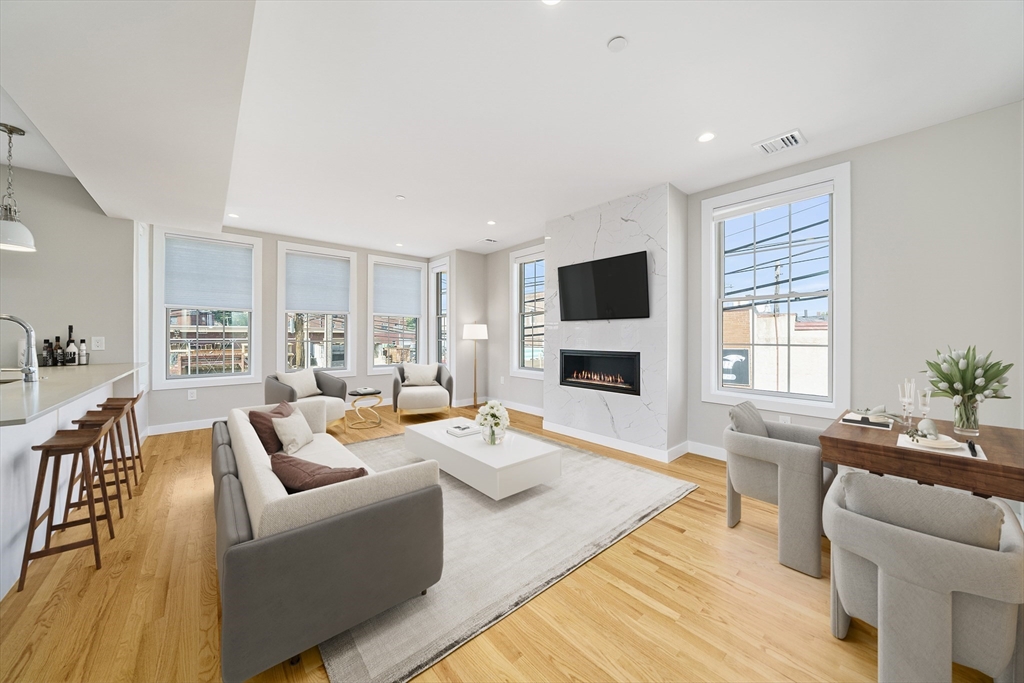 a living room with furniture fireplace and a flat screen tv