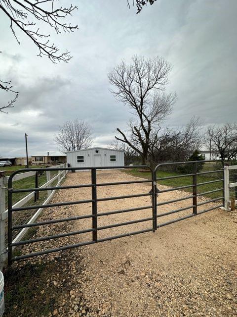 a view of a backyard with wooden fence