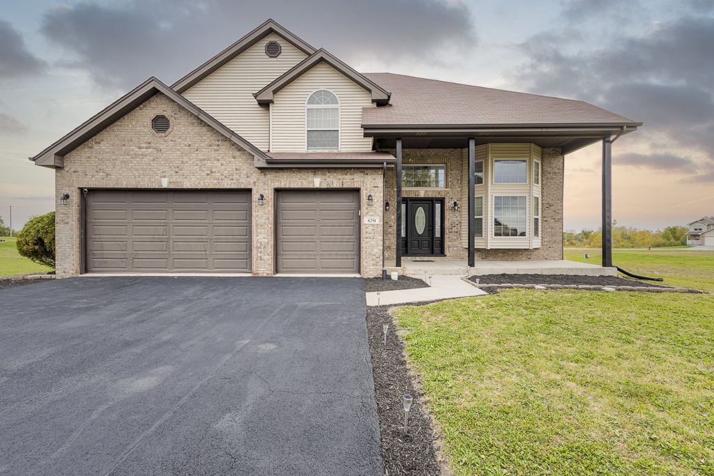 a front view of a house with a yard and garage