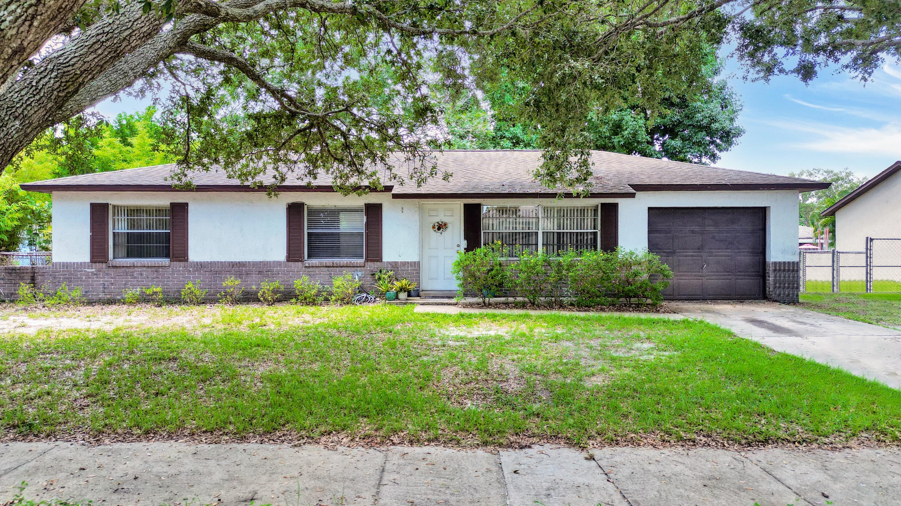 a front view of house with yard and green space