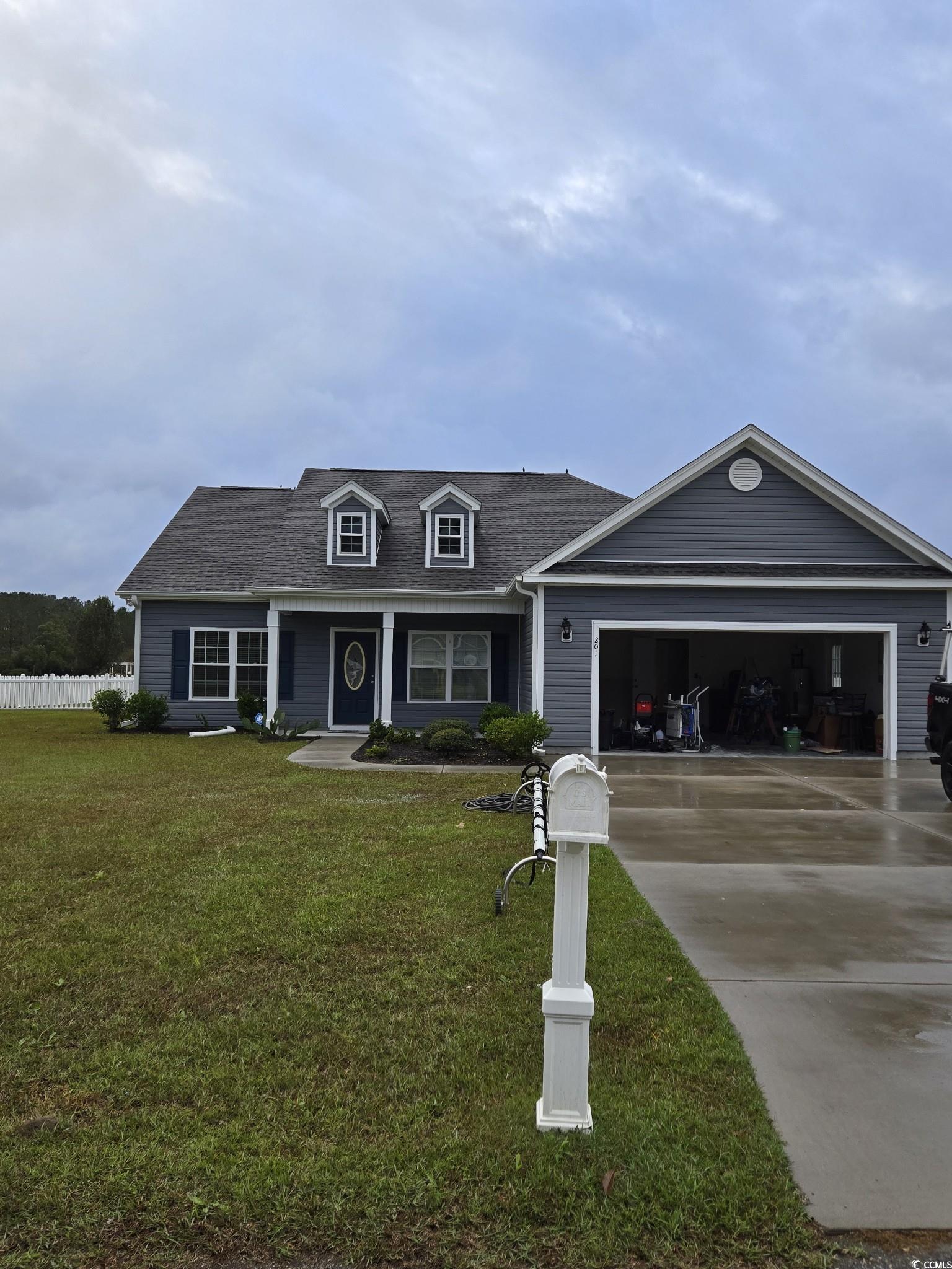 View of front of home featuring a garage and a fro