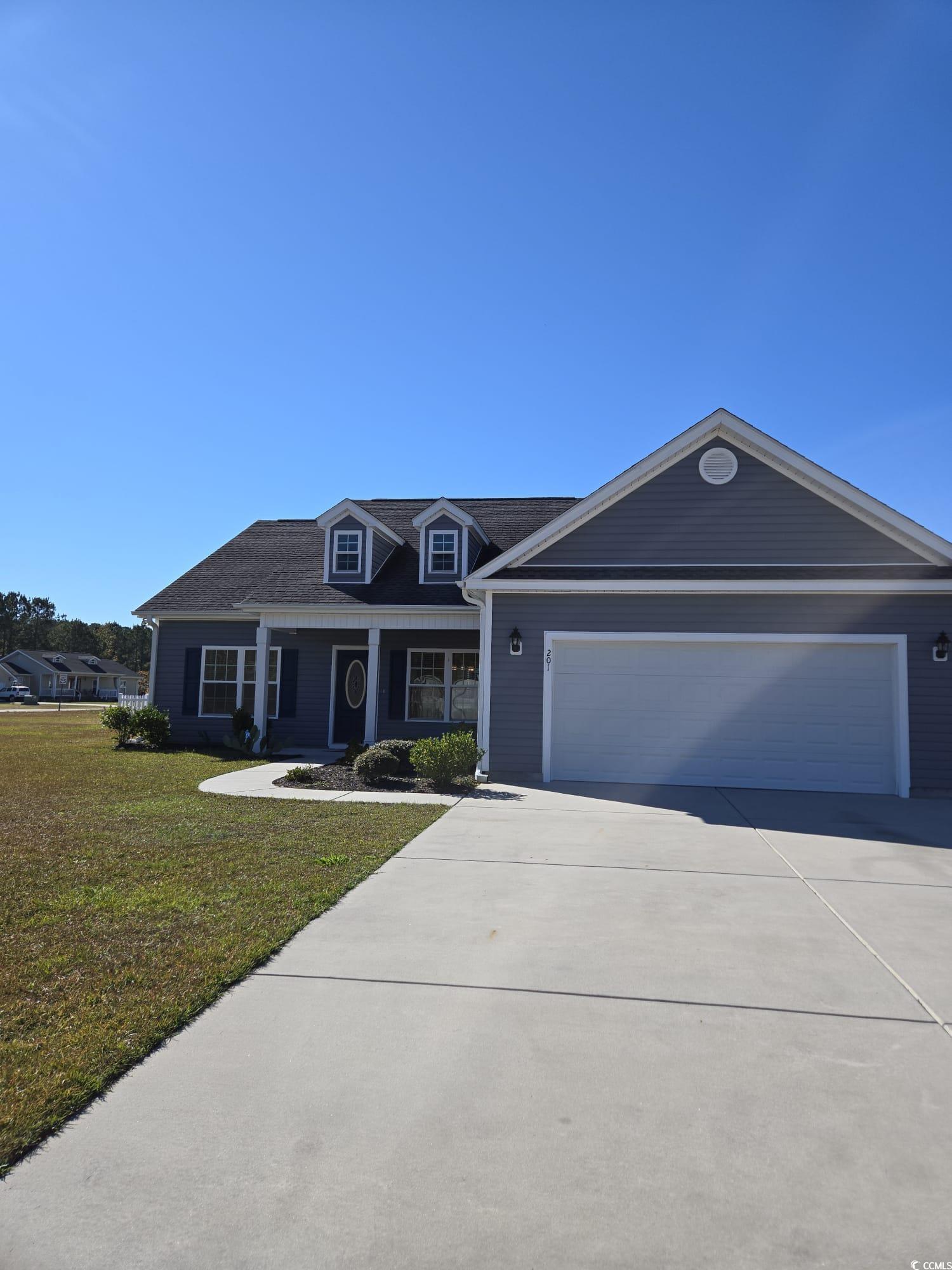 Ranch-style house with a garage and a front lawn