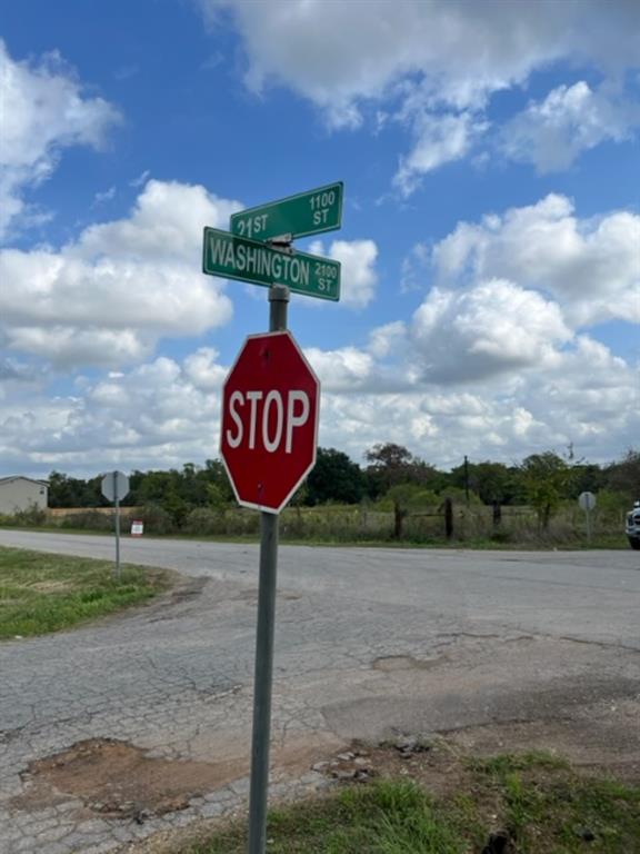 a sign board with a play ground in the back