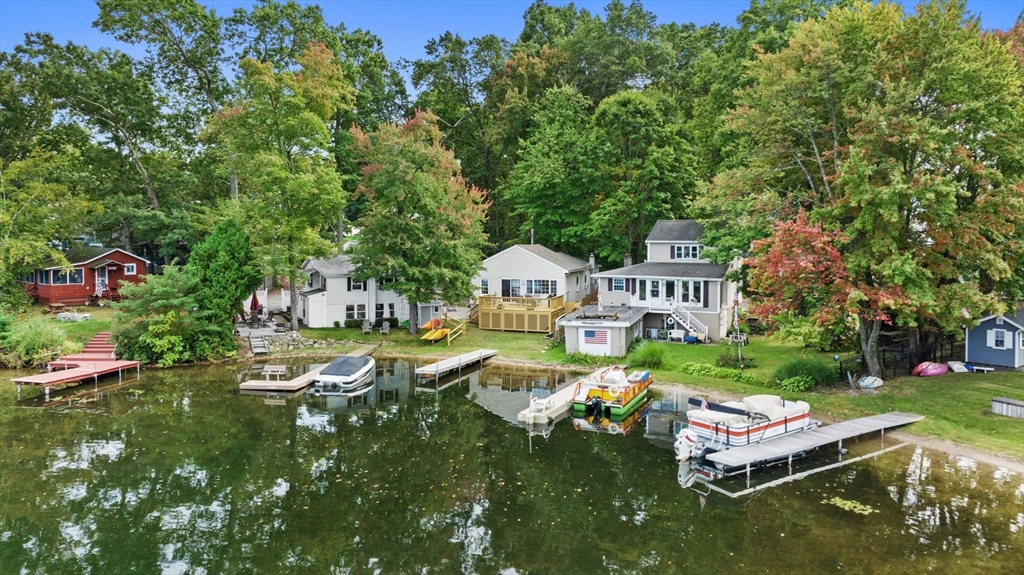 an aerial view of a house with swimming pool garden and patio