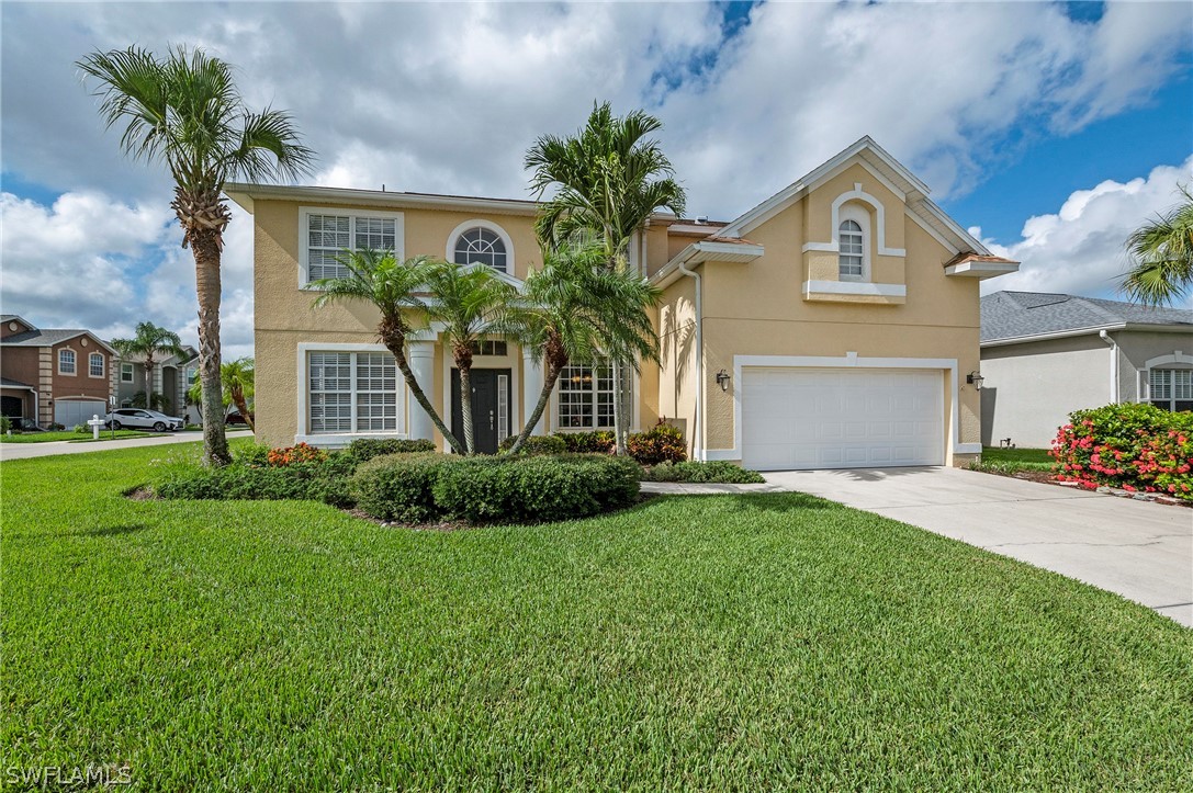 a front view of a house with a yard and garage