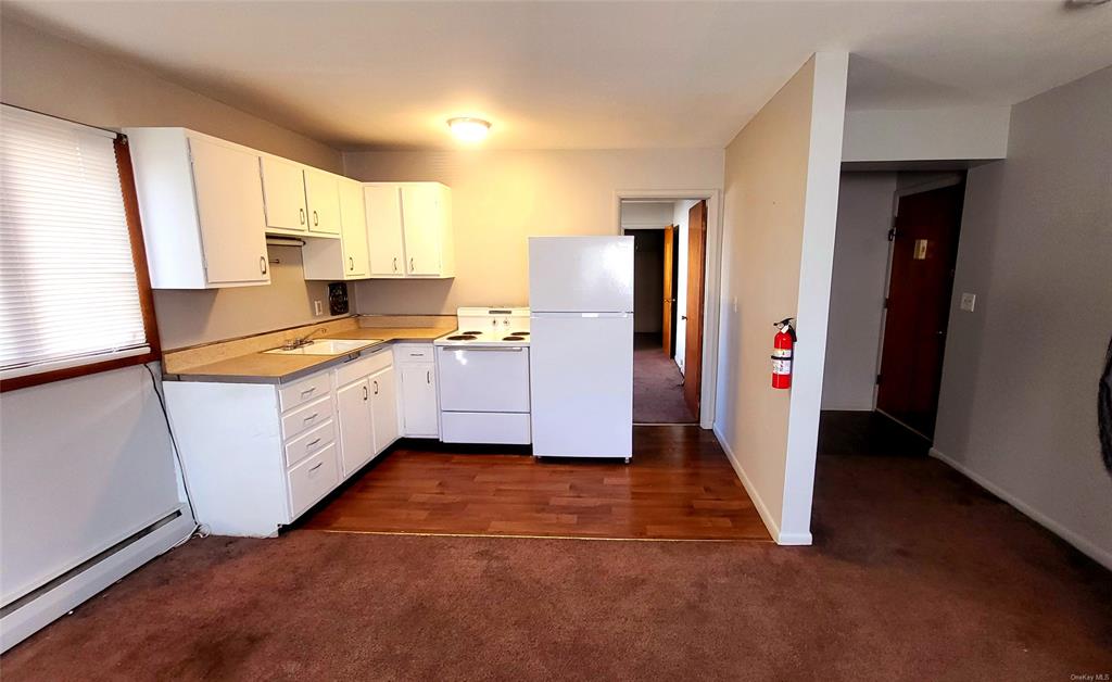 a kitchen with stainless steel appliances a refrigerator sink and cabinets