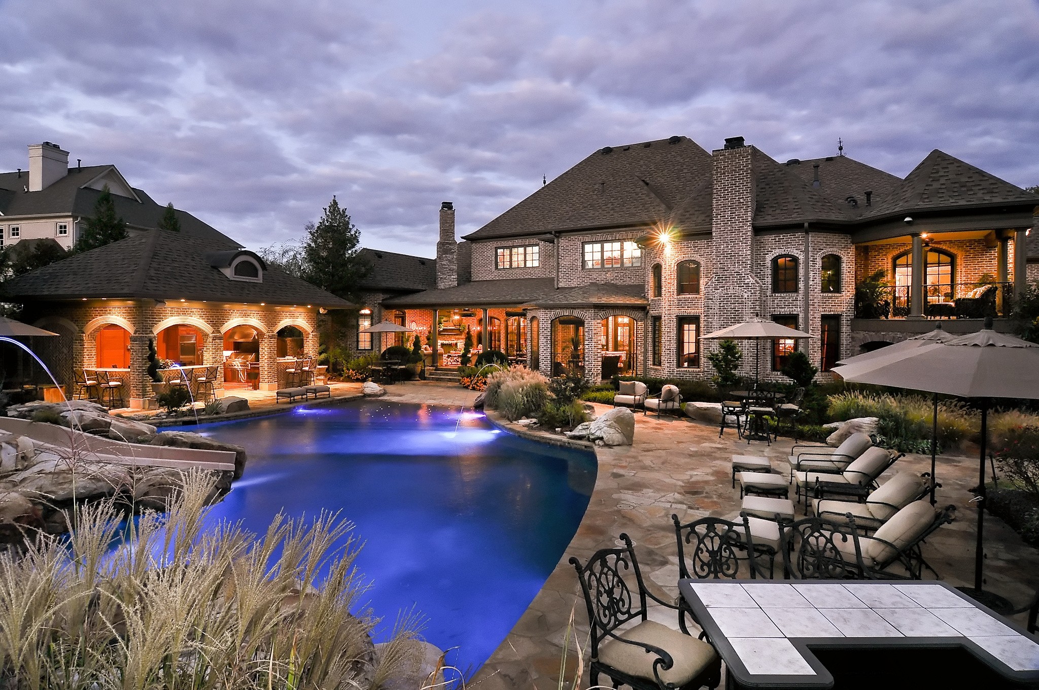 a view of a house with swimming pool and sitting area