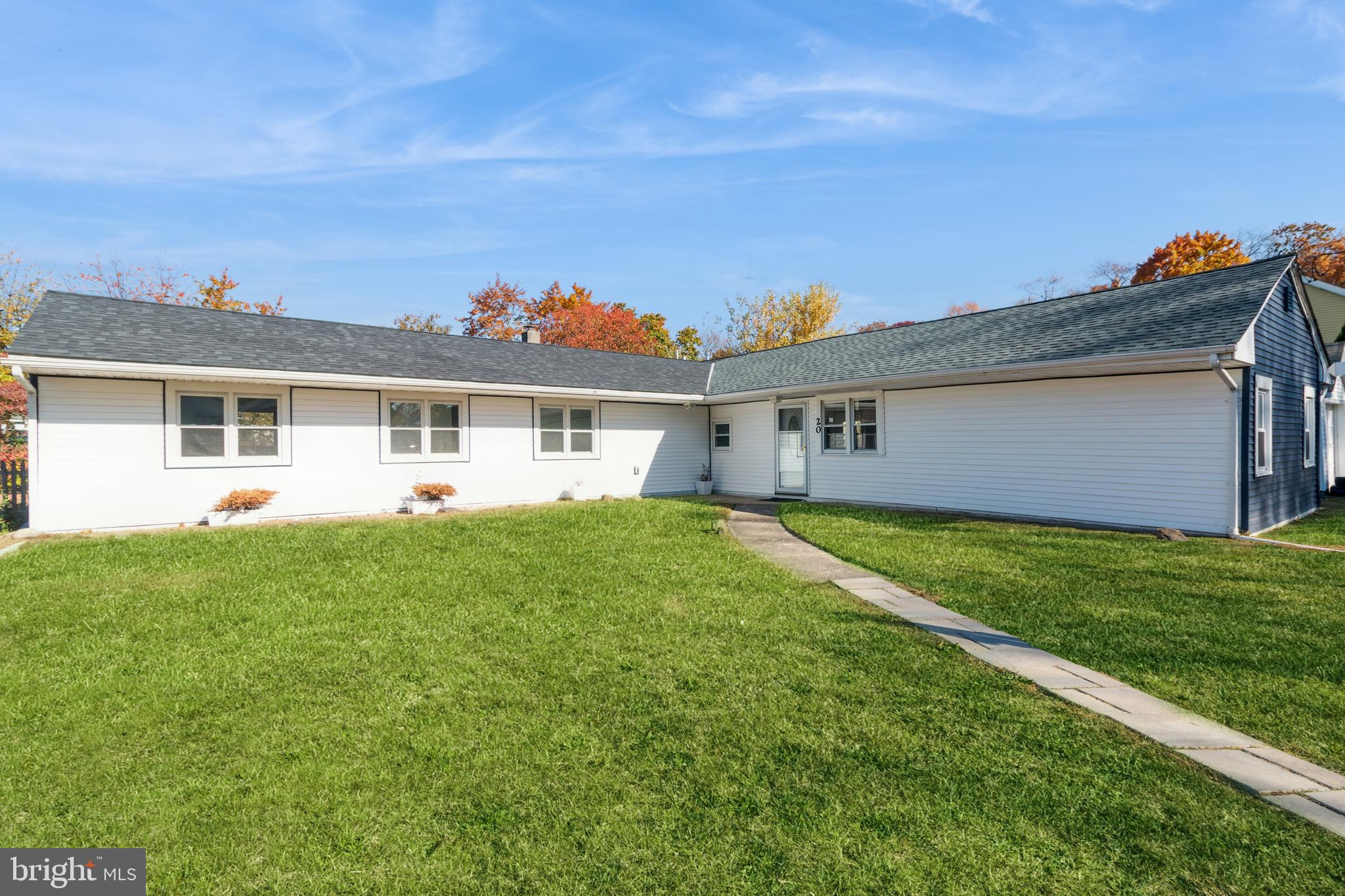 a view of a house with a backyard