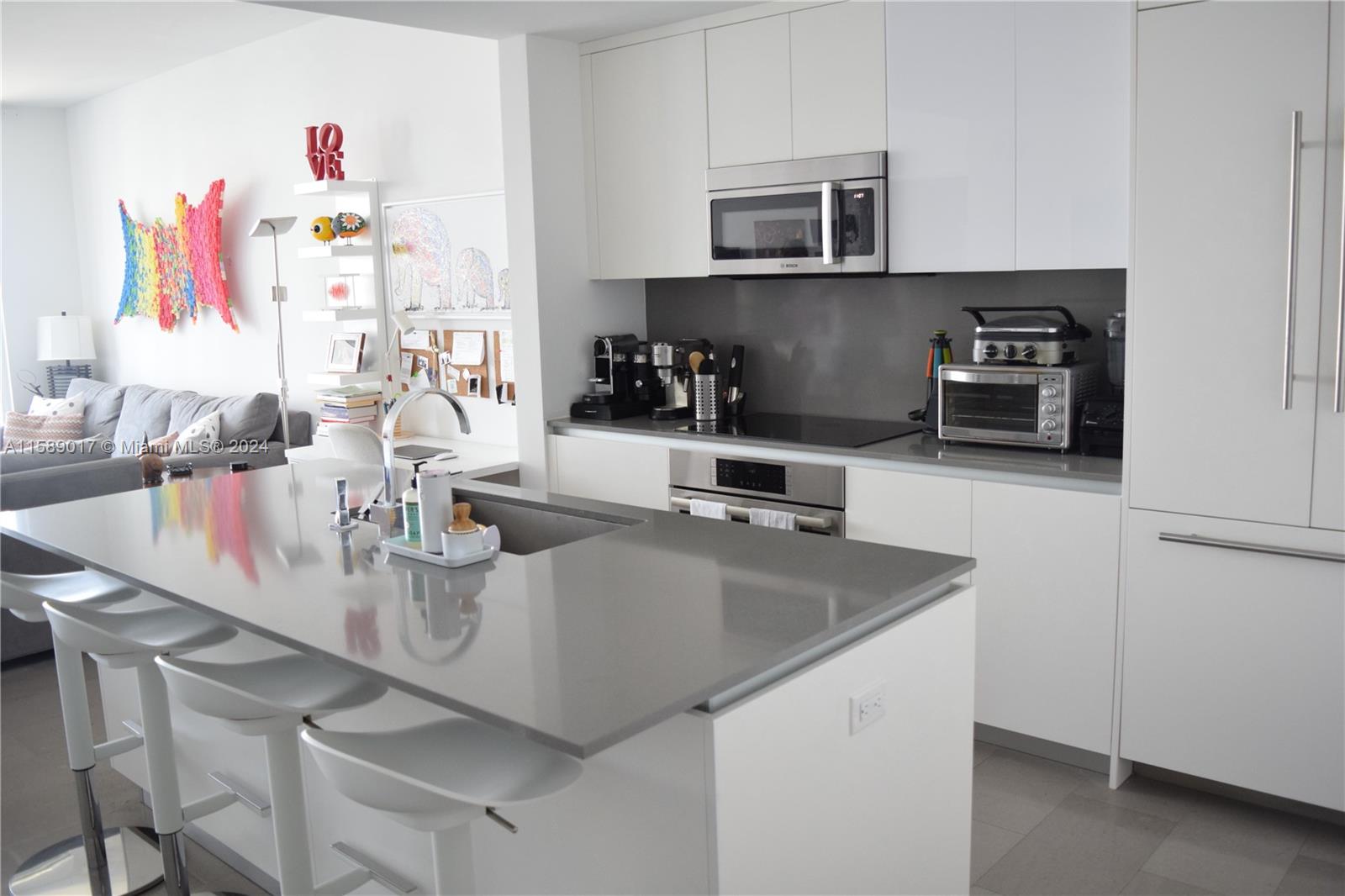 a kitchen with a sink a microwave and cabinets